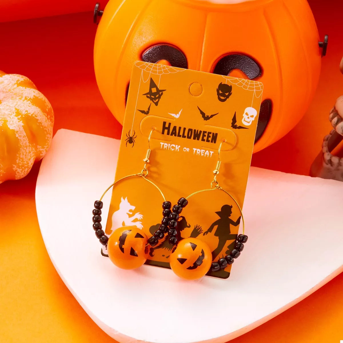 18K gold-plated Halloween bead earrings with orange pumpkin beads and black accent beads on hoops.