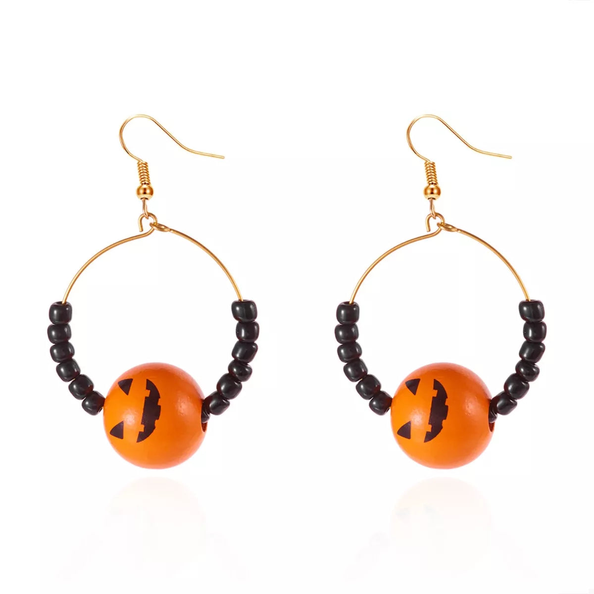 18K gold-plated Halloween bead earrings featuring orange pumpkin bead and black beads on a gold arc hoop